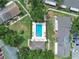 Aerial shot of a rectangular community pool surrounded by manicured landscaping and lounge chairs at 66 Silver Falls Cir, Kissimmee, FL 34743