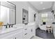Bright bathroom features a soaking tub, walk-in shower, and dual sink vanity with black accents at 6725 Sw 131St Cir, Ocala, FL 34481