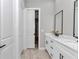 Bathroom featuring a dual sink vanity with quartz countertop and matte black hardware at 6725 Sw 131St Cir, Ocala, FL 34481