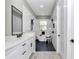 Bright bathroom features a soaking tub, walk-in shower, and dual sink vanity with black accents at 6725 Sw 131St Cir, Ocala, FL 34481