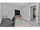 Bedroom with a large desk, sleek cabinet, and wood-look flooring at 6725 Sw 131St Cir, Ocala, FL 34481