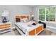 Stylish bedroom features a woven headboard, modern decor, and ample natural light, creating a peaceful and inviting atmosphere at 6725 Sw 131St Cir, Ocala, FL 34481