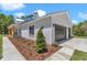 Exterior showing an attached garage with a manicured mulch garden and walkway at 6725 Sw 131St Cir, Ocala, FL 34481