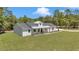 Charming, modern farmhouse with board and batten siding, metal roof, and a well maintained lawn at 6725 Sw 131St Cir, Ocala, FL 34481