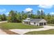 Beautifully landscaped modern farmhouse with attached two-car garage and concrete driveway at 6725 Sw 131St Cir, Ocala, FL 34481