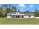 Beautiful single story home with a metal roof, covered porch with wood pillars, and a well manicured lawn at 6725 Sw 131St Cir, Ocala, FL 34481