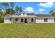 Attractive single story house features white siding and a inviting front porch with wood supports at 6725 Sw 131St Cir, Ocala, FL 34481