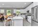 Spacious kitchen featuring white cabinets, quartz countertops, and stainless steel appliances at 6725 Sw 131St Cir, Ocala, FL 34481