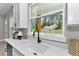 This kitchen shows a bright window and a clean white counter and cabinets at 6725 Sw 131St Cir, Ocala, FL 34481