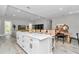 Open-concept living and dining area featuring a large kitchen island with seating, with views to the living room at 6725 Sw 131St Cir, Ocala, FL 34481