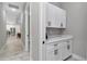 Hallway nook boasting white cabinets with black hardware and a quartz countertop at 6725 Sw 131St Cir, Ocala, FL 34481