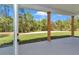 Covered patio with concrete floor and wood support columns overlooking the yard at 6725 Sw 131St Cir, Ocala, FL 34481