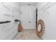 Walk-in closet featuring wire shelving and light wood floor, decorative mirror at 6725 Sw 131St Cir, Ocala, FL 34481
