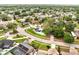 Aerial view of a home with a pool surrounded by a green lawn and mature landscaping at 819 Haulover Dr, Altamonte Springs, FL 32714