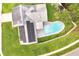Aerial view of house featuring solar panels, a pool, fenced backyard, and lawn at 819 Haulover Dr, Altamonte Springs, FL 32714
