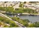 Aerial view of a lake with pedestrian bridge surrounded by lush greenery and roads at 819 Haulover Dr, Altamonte Springs, FL 32714