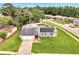 Aerial view of a single-story home with a solar panels, a pool, an attached garage, and a manicured front lawn at 819 Haulover Dr, Altamonte Springs, FL 32714