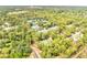 Aerial view of neighborhood tennis courts surrounded by lush green trees offering recreational opportunities for residents at 819 Haulover Dr, Altamonte Springs, FL 32714