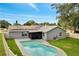 Aerial view of the backyard with a pool, a screened patio, and solar panels on the roof at 819 Haulover Dr, Altamonte Springs, FL 32714