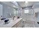 Bright bathroom features a shower over tub, white vanity, and updated faucet at 819 Haulover Dr, Altamonte Springs, FL 32714