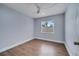 Bedroom with window, fan, wood-look floors and fresh paint at 819 Haulover Dr, Altamonte Springs, FL 32714