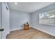 Bedroom with wood-look floors, window, closet, and modern light fixture at 819 Haulover Dr, Altamonte Springs, FL 32714