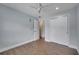 Bedroom with fan, wood-look floors, fresh paint, and closet with sliding door at 819 Haulover Dr, Altamonte Springs, FL 32714