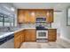 Kitchen has stainless steel appliances, granite counters, tile backsplash, and wood cabinets at 819 Haulover Dr, Altamonte Springs, FL 32714
