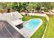 Aerial view of a backyard featuring a swimming pool with a -safety fence and solar panels on the roof at 819 Haulover Dr, Altamonte Springs, FL 32714