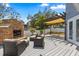 Outdoor living area with brick fireplace, patio furniture, and a pergola for relaxing or entertaining at 955 Seminole St, Clermont, FL 34711