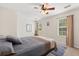 Inviting bedroom featuring a soft rug, ceiling fan, natural light, and calming neutral colors at 955 Seminole St, Clermont, FL 34711