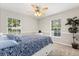 Inviting bedroom with ample natural light from two windows, a ceiling fan, and a cozy atmosphere at 955 Seminole St, Clermont, FL 34711