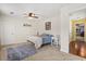 Cozy bedroom with carpet, ceiling fan, a guitar-themed rug, and natural light for comfort at 955 Seminole St, Clermont, FL 34711