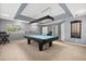 Spacious game room with a blue pool table, recessed lighting, and neutral walls at 955 Seminole St, Clermont, FL 34711