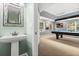 Powder room featuring a pedestal sink and a view of the game room at 955 Seminole St, Clermont, FL 34711