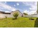 Manicured backyard with verdant lawn and white privacy fence surrounding the property at 11547 Grazeley Ct, Orlando, FL 32837