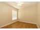 This bedroom features neutral walls, wood-look floors, and a window with white blinds at 11547 Grazeley Ct, Orlando, FL 32837