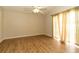 Empty bedroom featuring a ceiling fan, wood-look flooring, and neutral walls at 11547 Grazeley Ct, Orlando, FL 32837