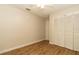 Bedroom with spacious closet and wood look flooring at 11547 Grazeley Ct, Orlando, FL 32837