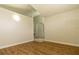 Cozy bedroom featuring wood-look flooring, neutral walls, and arched doorway at 11547 Grazeley Ct, Orlando, FL 32837