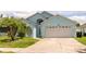 Charming single-Gathering home featuring a well-maintained lawn, two-car garage, and inviting curb appeal at 11547 Grazeley Ct, Orlando, FL 32837