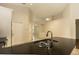 Granite countertops, modern faucet, and seamless integration with living space at 11547 Grazeley Ct, Orlando, FL 32837