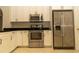 Close-up showcasing the sleek stainless steel appliances and ample cabinet space in the modern kitchen at 11547 Grazeley Ct, Orlando, FL 32837
