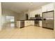 Modern kitchen with stainless steel appliances, white cabinetry, and a spacious island counter at 11547 Grazeley Ct, Orlando, FL 32837