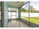 Enclosed patio features tile floor and screen walls overlooking the backyard at 11547 Grazeley Ct, Orlando, FL 32837