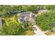Aerial view of a well-maintained home with a spacious backyard, lush landscaping, and a long driveway at 12636 Hammock Pointe Cir, Clermont, FL 34711