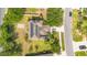 Aerial view of a home with solar panels and a backyard with mature trees on a verdant lot at 12636 Hammock Pointe Cir, Clermont, FL 34711