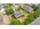 Aerial view of home with solar panels on roof, lush trees, and well maintained lawn at 12636 Hammock Pointe Cir, Clermont, FL 34711