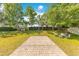 Backyard features a basketball court, seating, and mature trees at 12636 Hammock Pointe Cir, Clermont, FL 34711