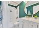 Well-lit bathroom features a combination tub and shower and a pristine white vanity with gold accents at 12636 Hammock Pointe Cir, Clermont, FL 34711